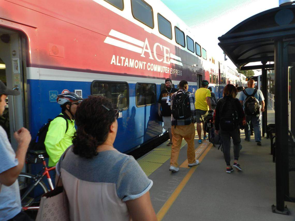 Riders disembark from an Altamont Corridor Express train at a station serving Lathrop and Manteca in 2016.