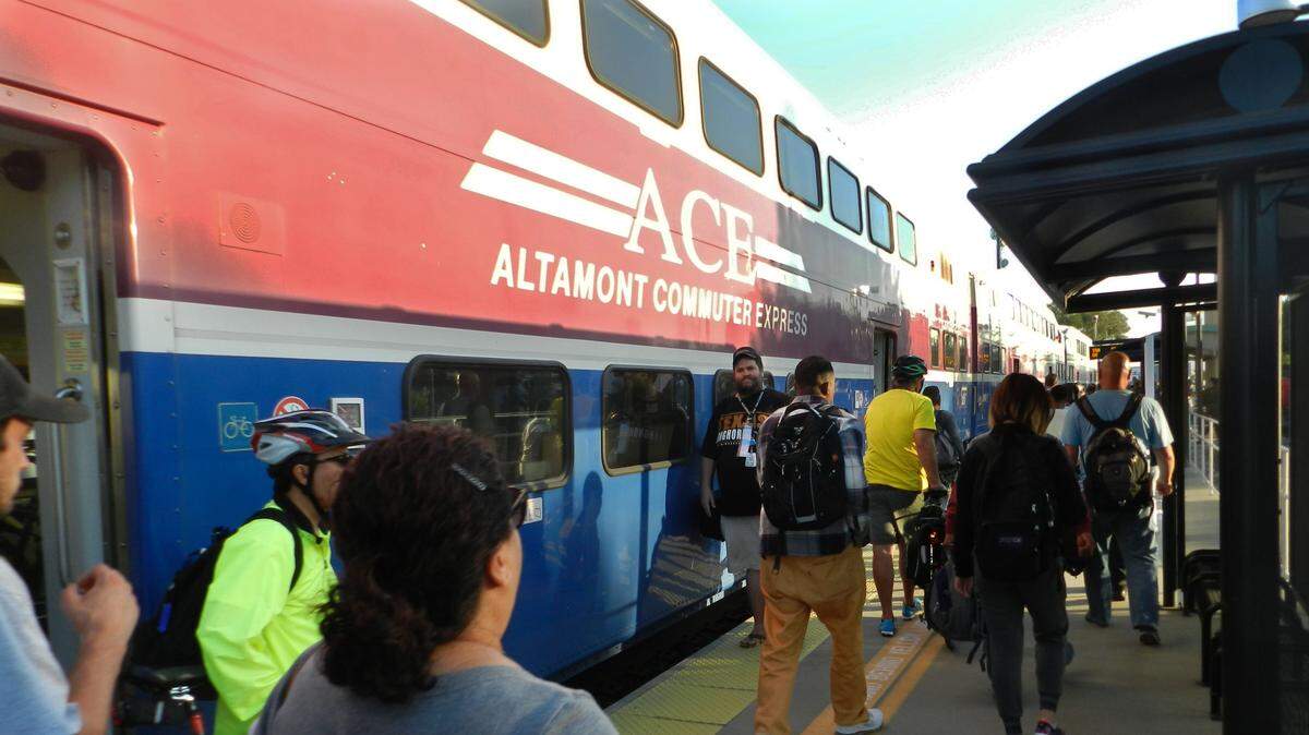 Riders disembark from an Altamont Corridor Express train at a station serving Lathrop and Manteca in  2016.