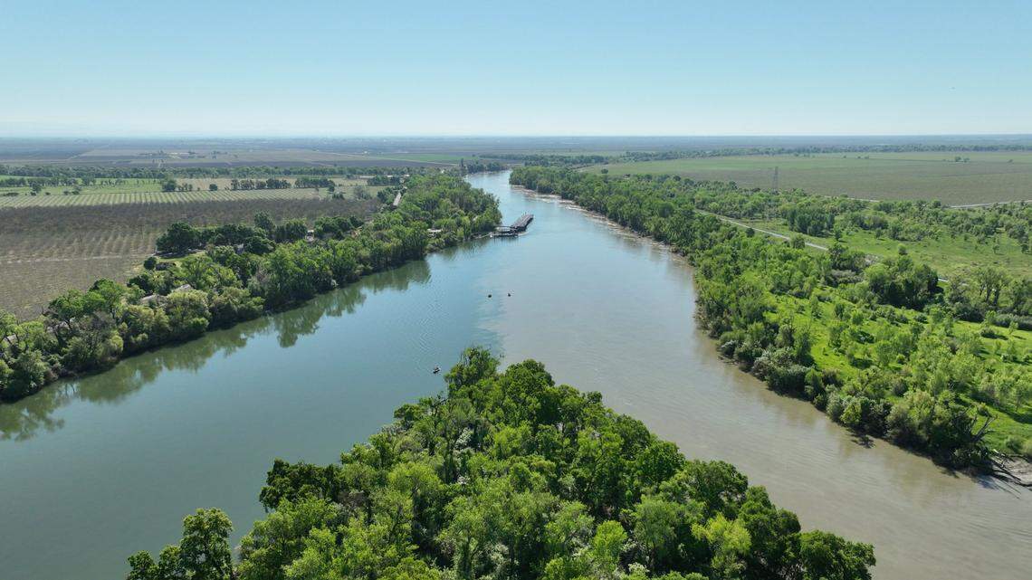 An aerial photograph shows the confluence of the Sacramento and Feather rivers near Knights Landing. Under new state regulations, some water districts will be required to make significant conservation efforts over the next two years. Many water providers in the Sacramento region will have little or no cuts imposed.