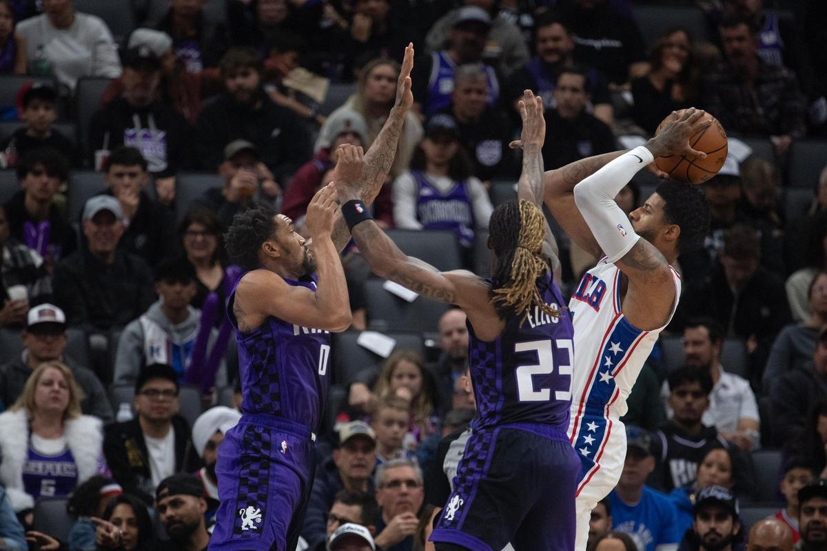 Philadelphia 76ers forward Paul George (8) shoots over Sacramento Kings guard Malik Monk (0) and guard Keon Ellis (23) in the first half on Wednesday, Jan. 1, 2025 at Golden 1 Center.