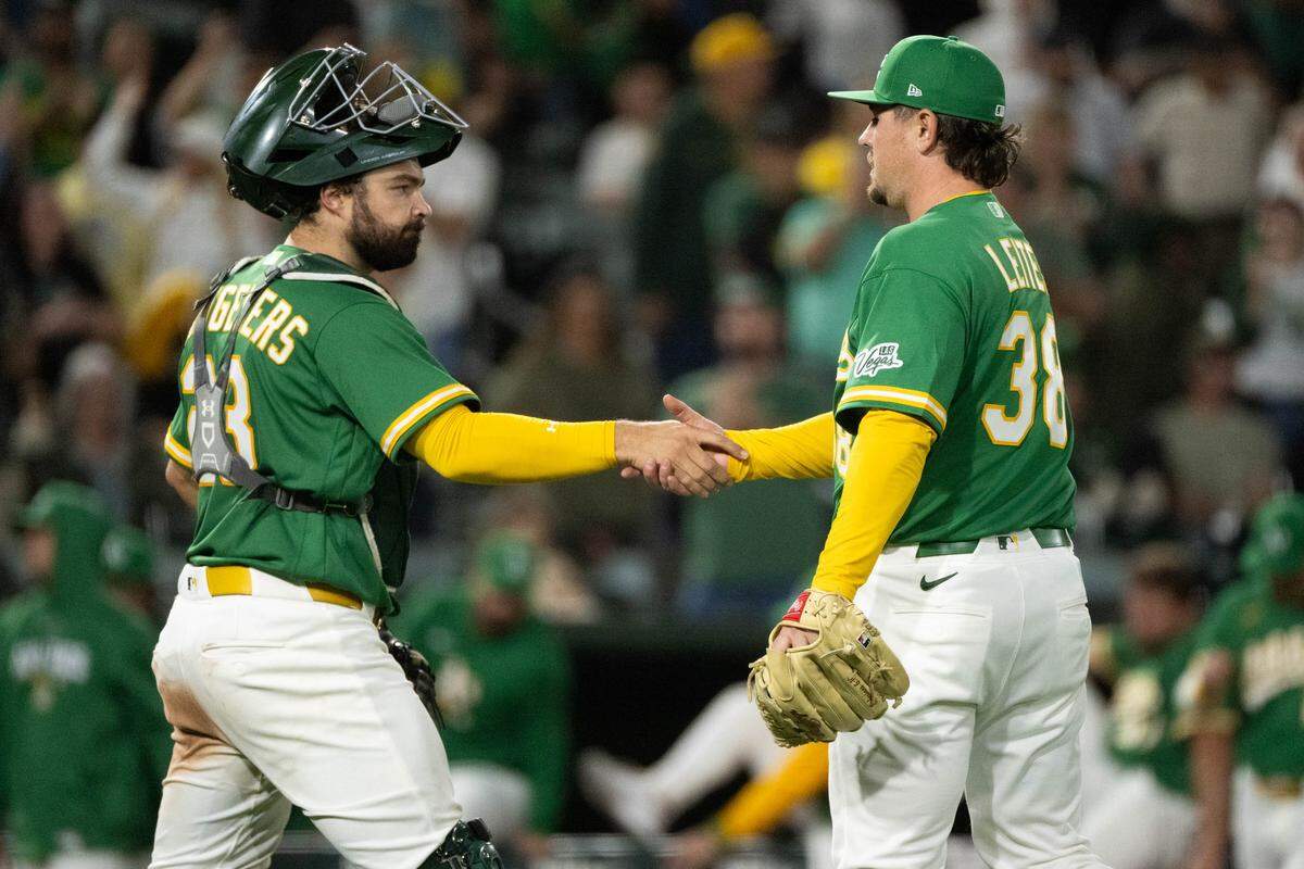 Athletics catcher Shea Langeliers (23) congratulates Athletics pitcher Mark Leiter Jr. (38) after striking out Kansas City Royals right fielder Jac Caglianone (14) in the ninth inning during a game at Sutter Health Park on Wednesday.