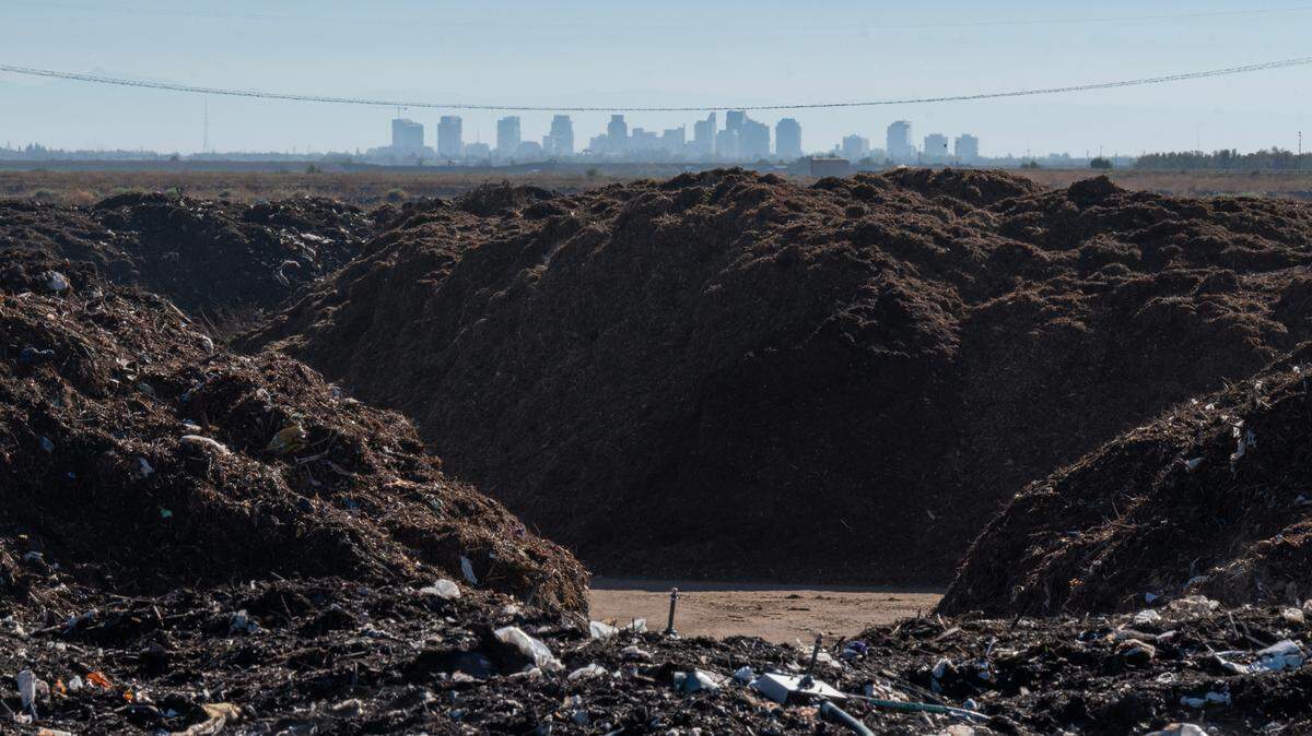 The Sacramento skyline stands in the distance as piles of organic waste are processed at the Yolo County Central Landfill in September 2022. On Nov. 4, 2025, the California Air Resources Board approved updates to its Landfill Methane Regulation for the first time in more than 15 years.