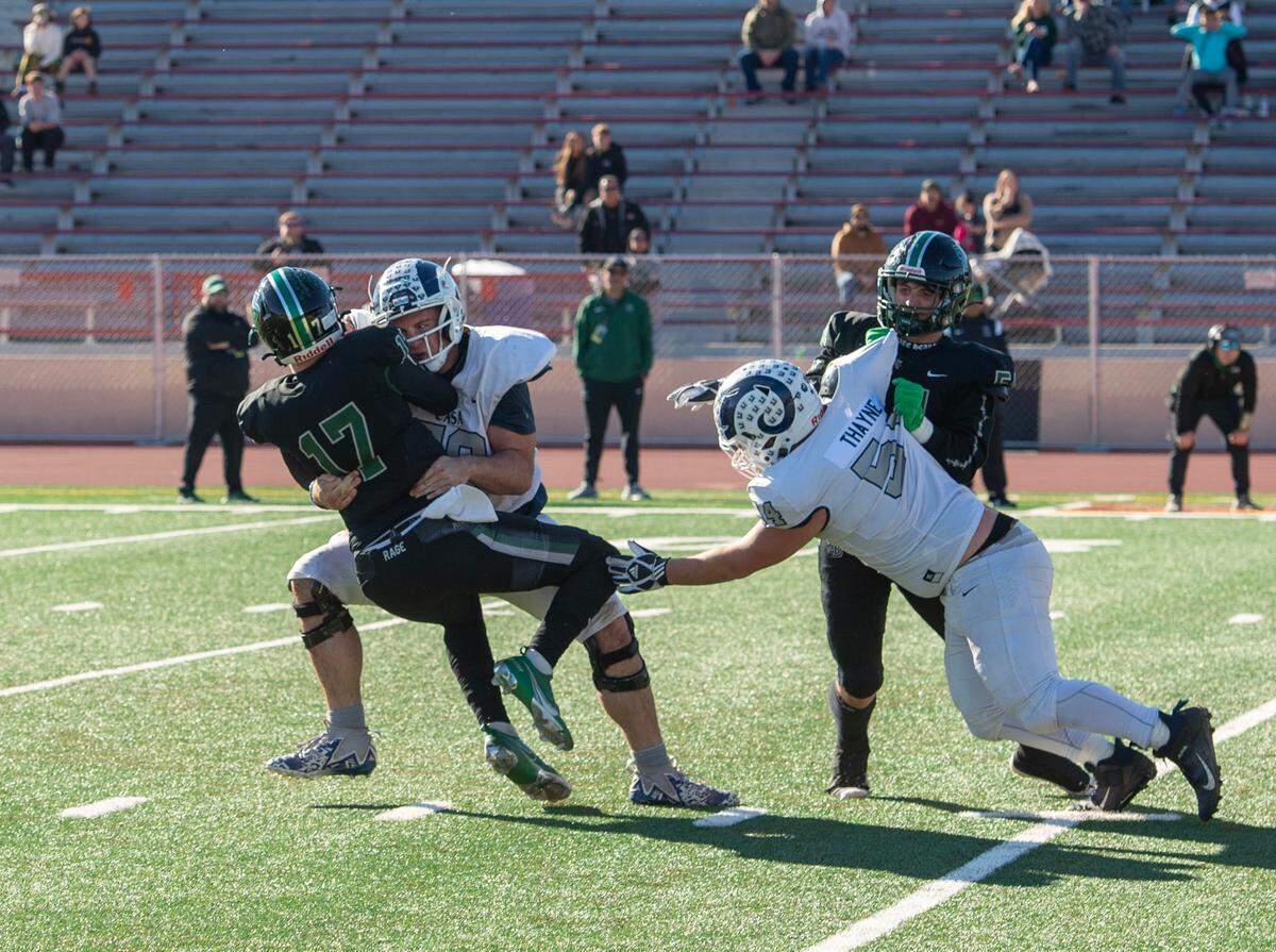 The Casa Roble Rams’ Darren Dalton (79) sacks Twelve Bridges Raging Rhinos quarterback Whit Kruse (17) on second down of the Rhinos’ final possession of the CIF Sac-Joaquin Section Division V football championship game on Friday, Nov. 24, 2023, at Hughes Stadium.