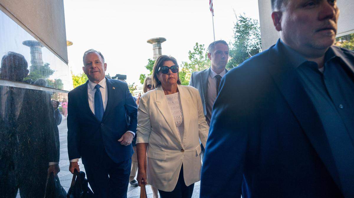 Dana Williamson, center, enters the Robert T. Matsui U.S. Courthouse in Sacramento, where she pleaded guilty to bank fraud, filing a false tax return and lying to the FBI in a corruption scandal, on Thursday. Williamson previously advised both Gov. Gavin Newsom and gubernatorial candidate Xavier Becerra.



