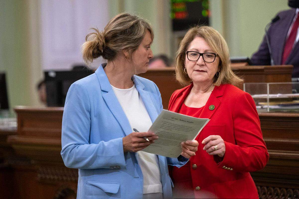 Eloise Gómez Reyes, right, talks with Assembly colleague Buffy Wicks during session on Thursday, June 1, 2023. Reyes, now a state senator, sponsored legislation in 2018 to create Dolores Huerta Day. 