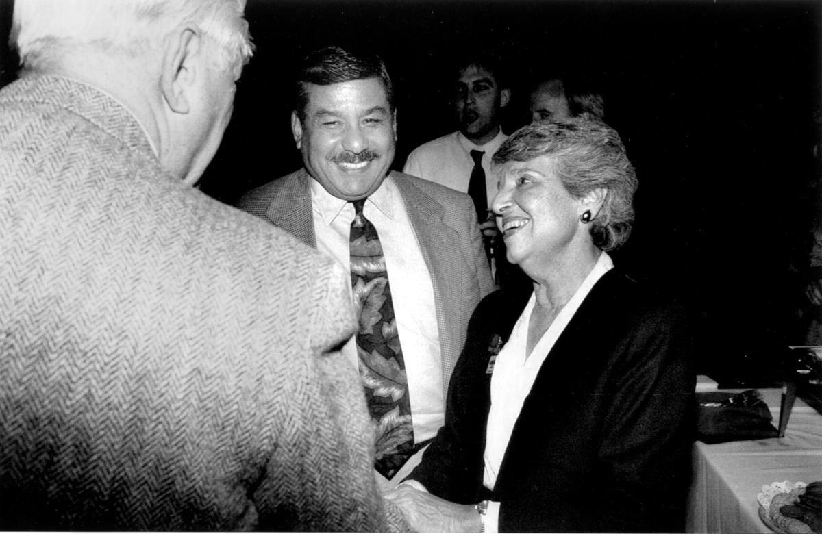 Incoming Mayor Joe Serna and outgoing Mayor Anne Rudin accept congratulations from a well-wisher at a gathering in the Bull Market restaurant, following the outgoing council’s final meeting.