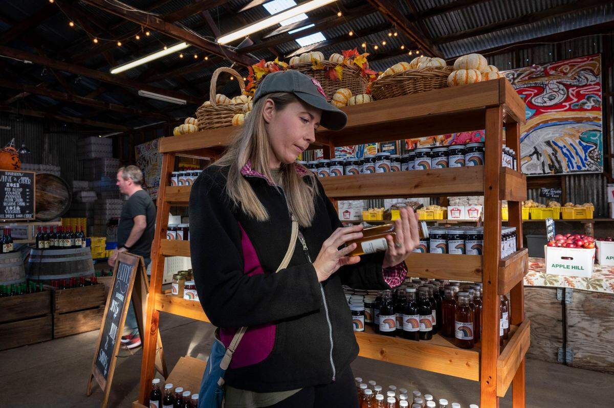 Jennifer Horzelski, of Michigan, looks at some of the items for sale at Rainbow Orchard in Camino on Nov. 17. The pandemic and the summers Caldor Fire made business complicated for members of the Apple Hill Growers Association.