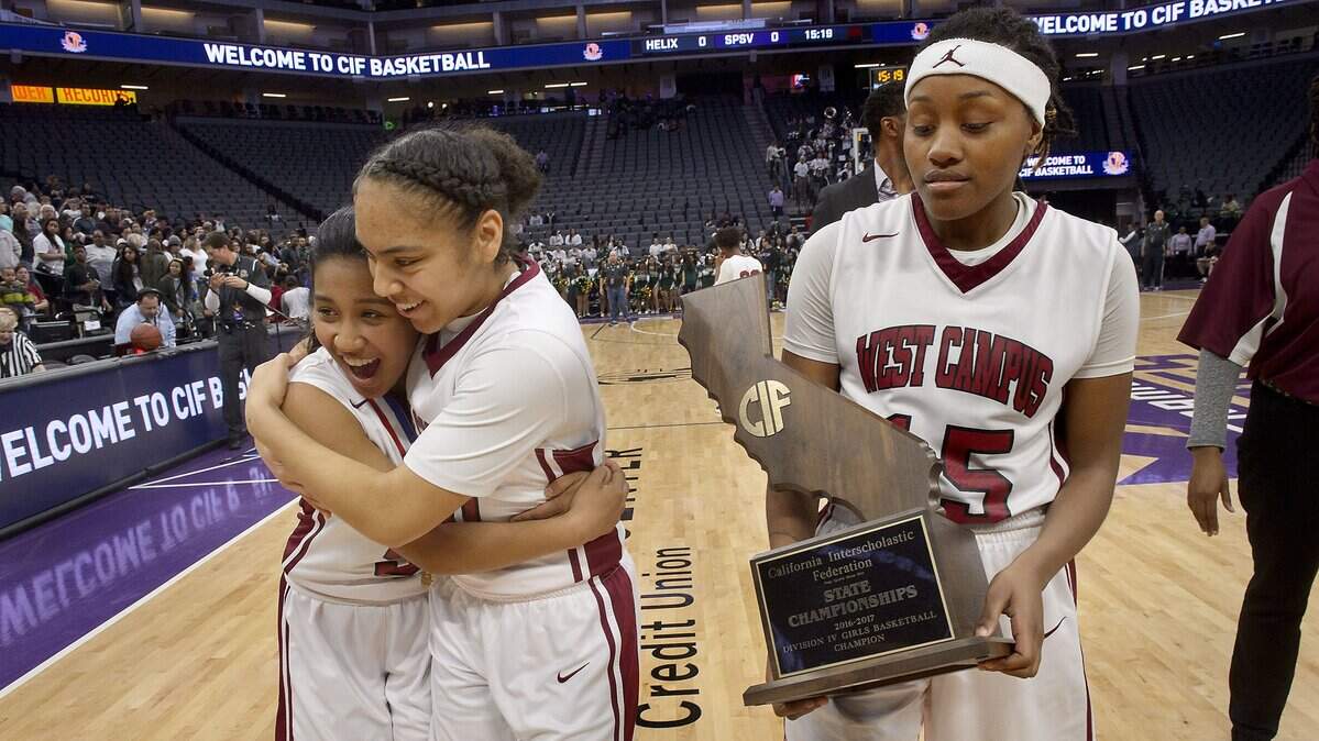 West Campus players Gabriella Rones, left, Anthonya Sanchez and Namiko Adams celebrate their CIF State Division IV girls basketball title last year at Golden 1 Center. The Kings' arena will continue to host the high school through 2021 under a deal announced Monday.