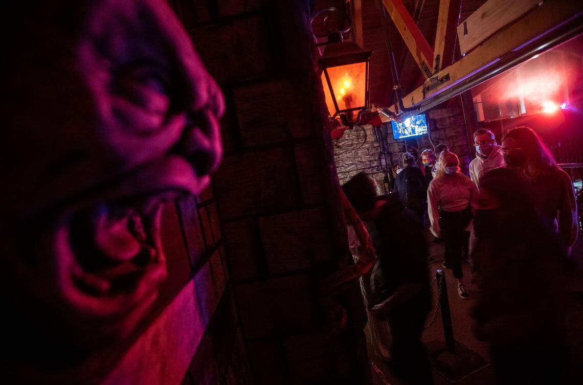 People wait in line and listen to Bella Hernandez of Rancho Cordova on their way into The Ward at Heartstoppers Haunted House in Rancho Cordova in 2021. The haunt runs through Saturday, Nov. 1.