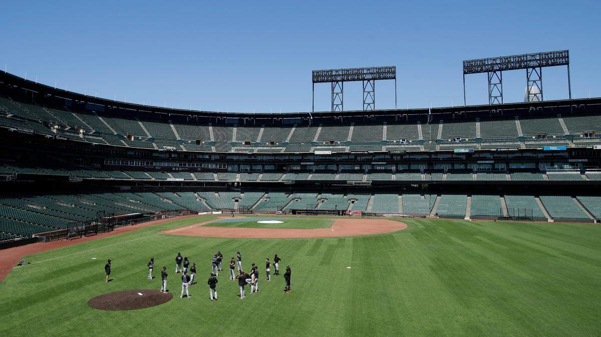 San Francisco Giants gather in the outfield at Oracle Park during a baseball practice in San Francisco, Sunday, July 5.