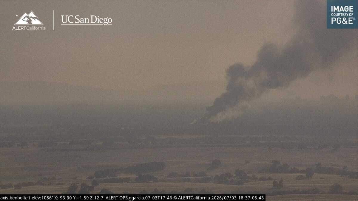 Smoke rises from a fire in Rancho Cordova as seen by an AlertCalifornia wildfire surveillance camera mounted atop Ben Bolte Ridge near the Sacramento Amador county line on Friday. The fire at an auto wrecking yard on Recycle Road was reported about 5:45 p.m. after multiple vehicles stacked on racks caught fire.