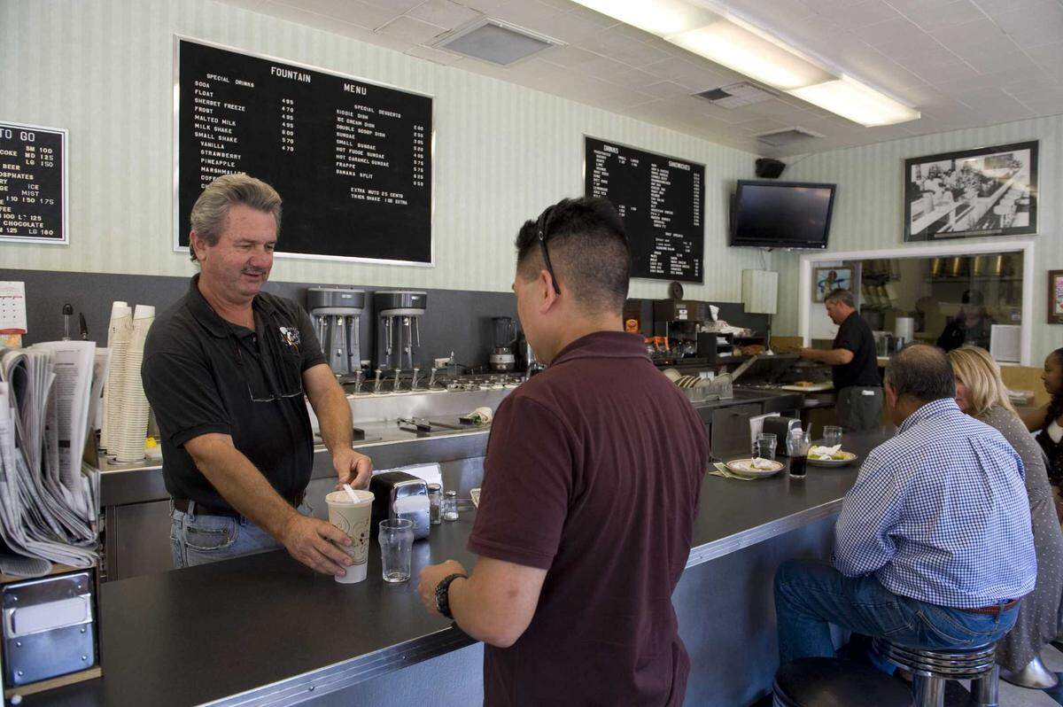 Craig Rutledge serves a customer on Tuesday, September 14, 2010, at Vic’s Ice Cream shop in Land Park. Rutledge, who operated the ice cream parlor for 40 years, died Monday at the age of 73.