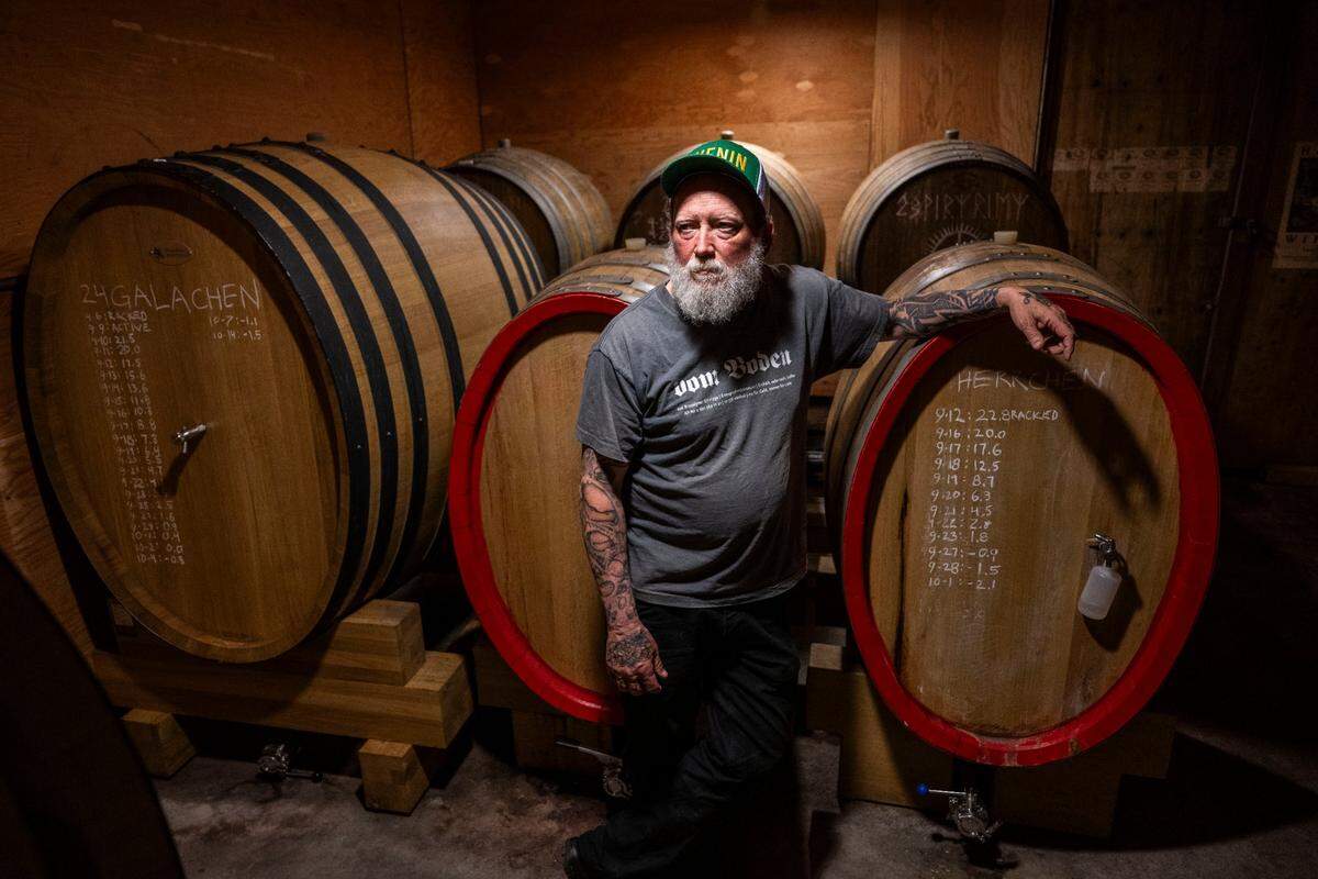 Craig Haarmeyer, owner of Haarmeyer Wine Cellars, stands in front of barrels at Haarmeyer Wine Cellars in West Sacramento last month.
