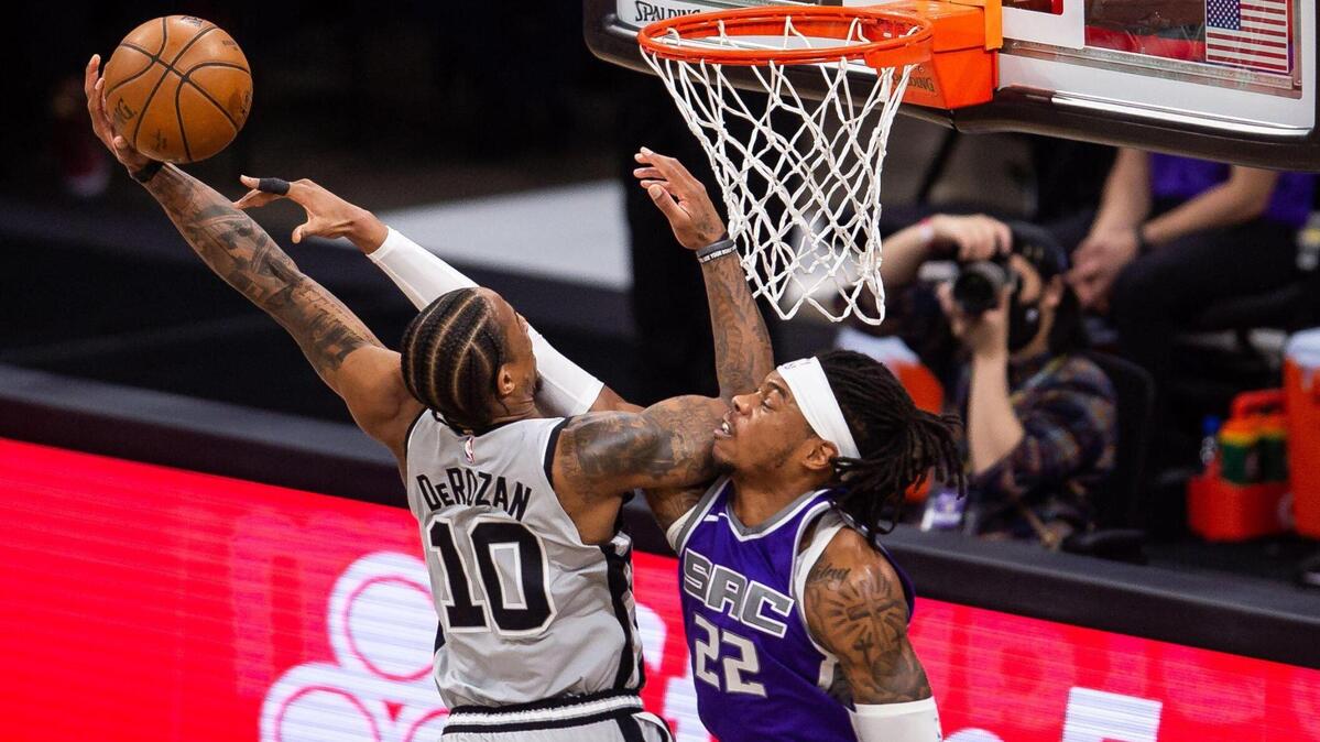 Sacramento Kings forward Richaun Holmes (22), right, is called for a foul as he denies San Antonio Spurs guard-forward DeMar DeRozan (10) a slam dunk during the first period of the NBA game Friday, May 7, 2021, at Golden 1 Center in downtown Sacramento.