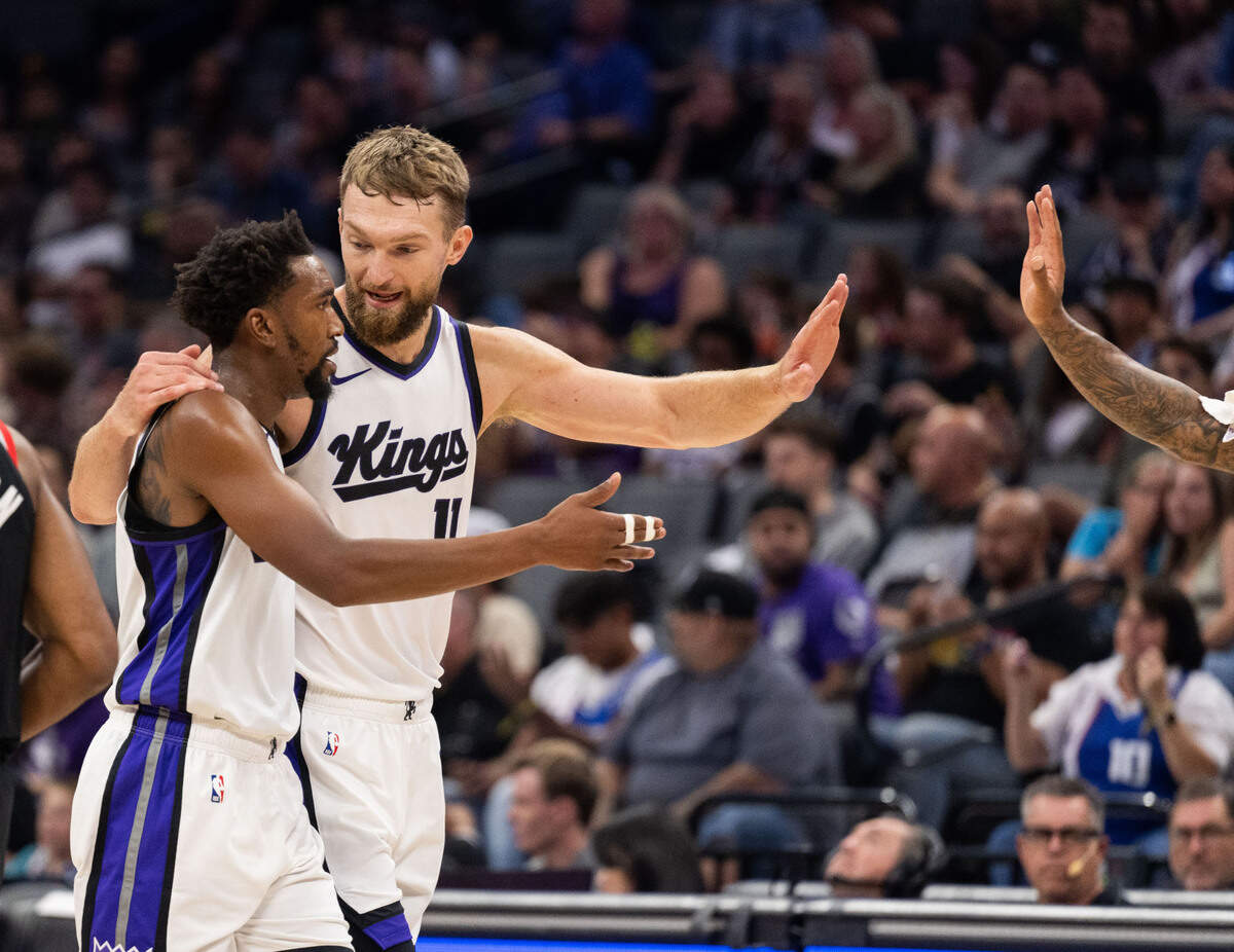 Sacramento Kings guard Malik Monk (0) and teammate Sacramento Kings forward Domantas Sabonis (11) walk off the court during a preseason NBA game on Oct. 13, 2024 at Golden 1 Center.