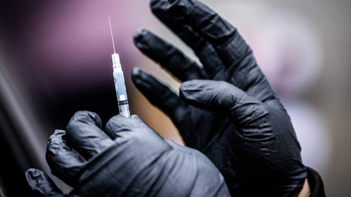 A medical professional gets ready to administer a Pfizer COVID-19 vaccine at Natomas High School on Thursday, Feb. 18, 2021. Health experts are recommending COVID-19 vaccines, flu shots and RSV vaccines and other treatments in 2023 to prevent another “tripledemic” from overwhelming hospitals.