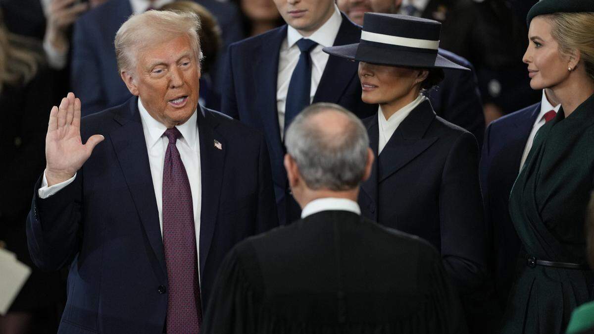 Jan 20, 2025; Washington, DC, USA; Donald Trump is sworn in as the 47th president of the United States by Chief Justice John Roberts as Melania Trump holds the Bible during the 60th Presidential Inauguration in the Rotunda of the U.S. Capitol in Washington, Monday, Jan. 20, 2025. Mandatory Credit: Julia Demaree Nikhinson-Pool via Imagn Images

