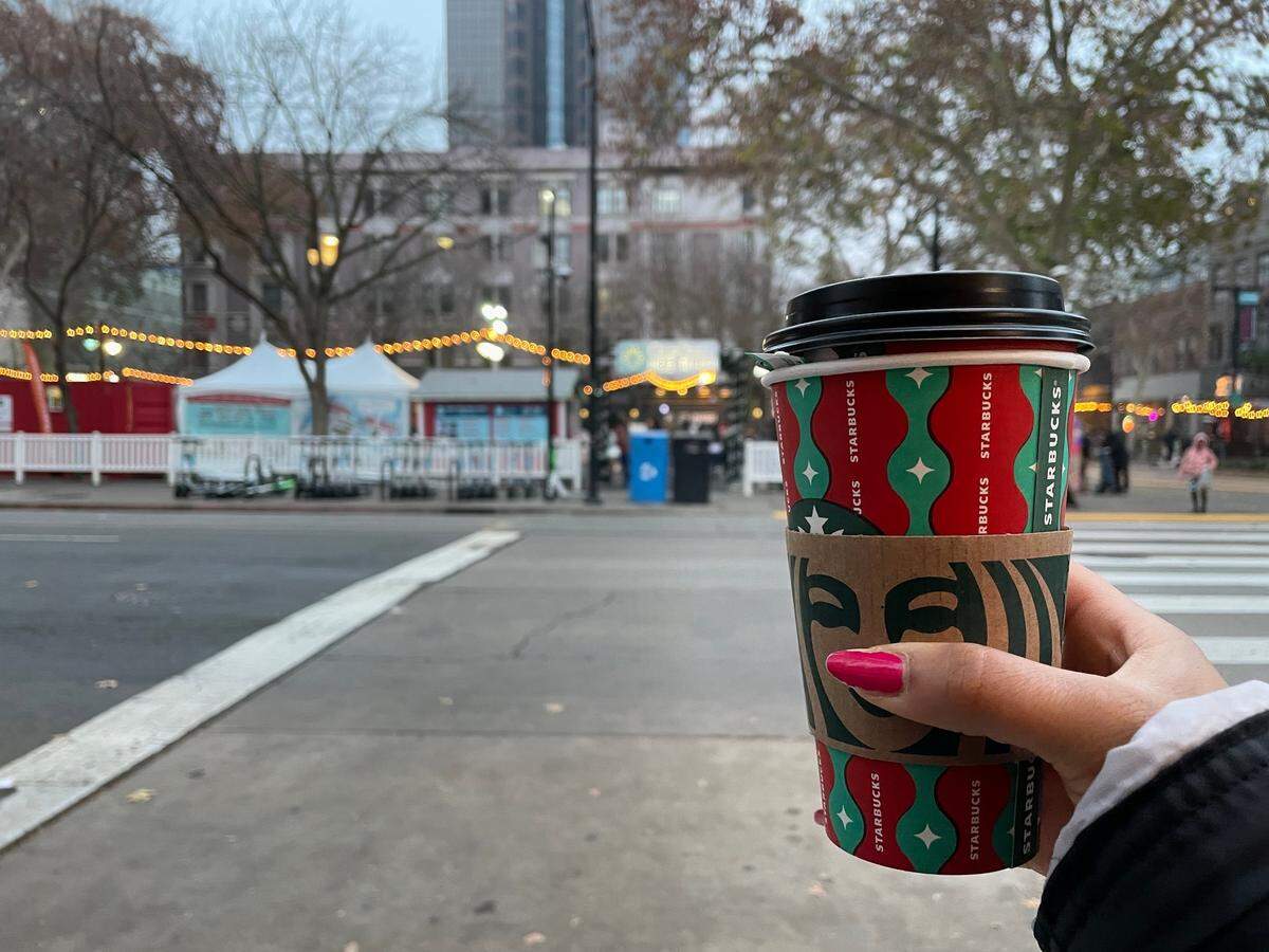 Service Journalism reporter Brianna Taylor visits Downtown Sacramento Ice Rink at 701 K St., Sacramento on Sunday, Dec. 18, 2022. After the ice, she warms up with a honey citrus mint hot tea and an everything bagel for $7.50 from the Starbucks across the street from the rink.