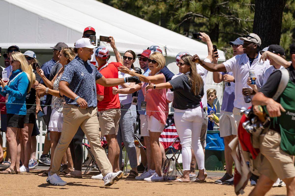 Kansas City Chiefs quarterback Patrick Mahomes II greets fans as he walks to the seventeenth green during the American Century Celebrity Golf Championship Tournament at Edgewood Tahoe Golf Course in Stateline, Nev., on Sunday, July 10, 2022.