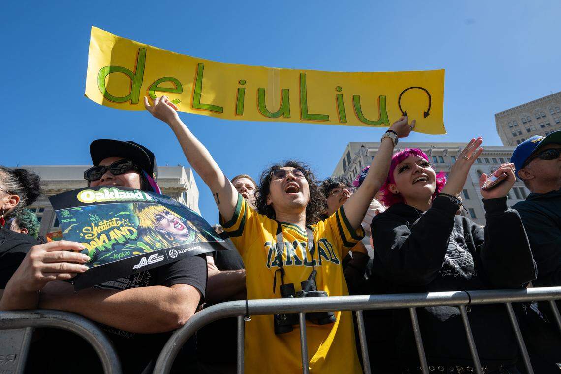 Tammy Mah Ung, Kenny Jong and April Salazar cheer during a celebration rally or Alysa Liu at the Frank Ogawa Plaza in Oakland on Thursday. Thousands came out to honor Liu for her Gold Medal in Women’s Ice Skating at the Milano Cortina 2026 Olympics.
