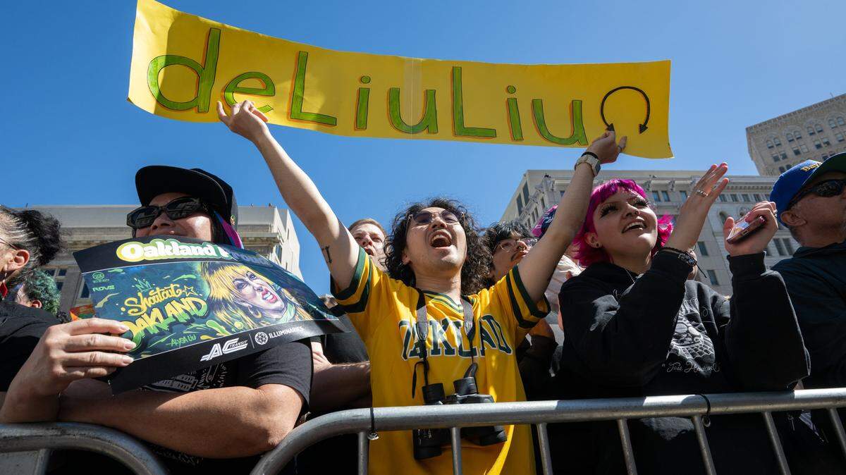 Tammy Mah Ung, Kenny Jong and April Salazar cheer during a celebration rally or Alysa Liu at the Frank Ogawa Plaza in Oakland on Thursday. Thousands came out to honor Liu for her Gold Medal in Women’s Ice Skating at the Milano Cortina 2026 Olympics.