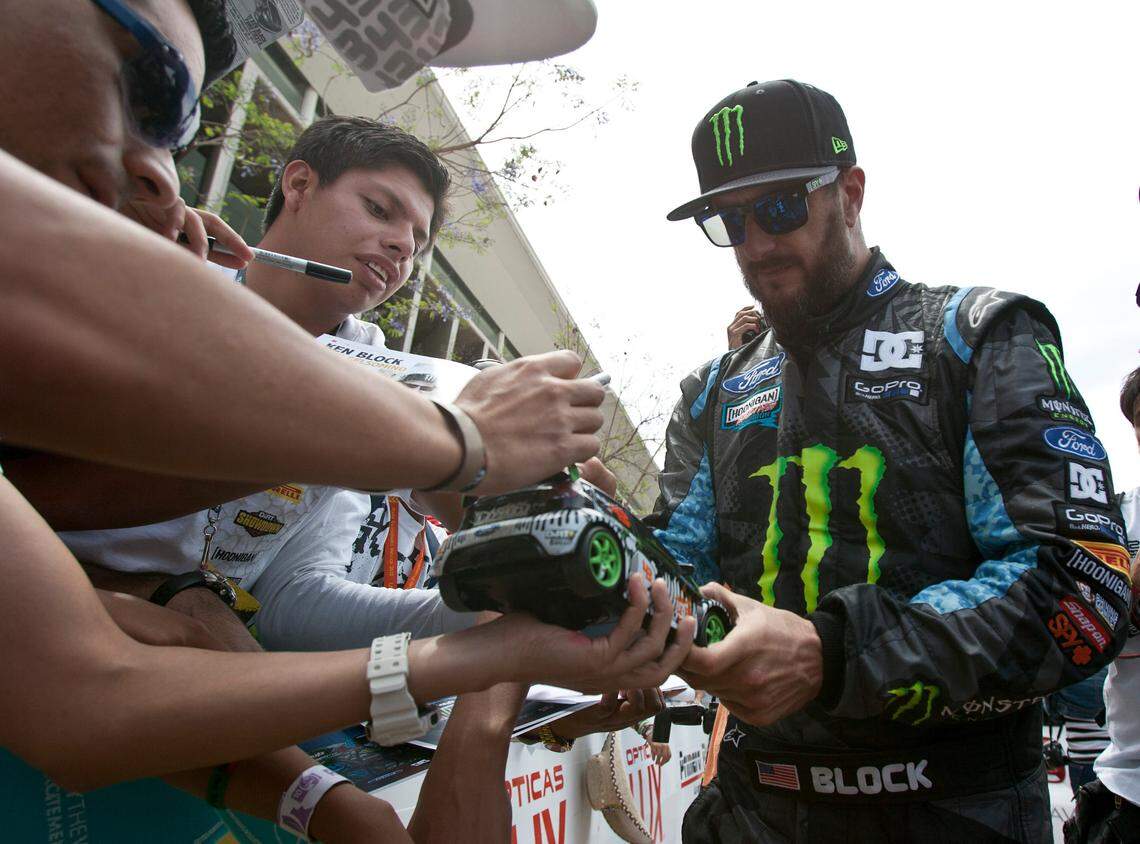 Hoonigan Racing Division driver Ken Block, right, signs autographs at the end of the Mexico Rally in Leon, Mexico, Sunday, March 10, 2013. (AP Photo/Christian Palma)