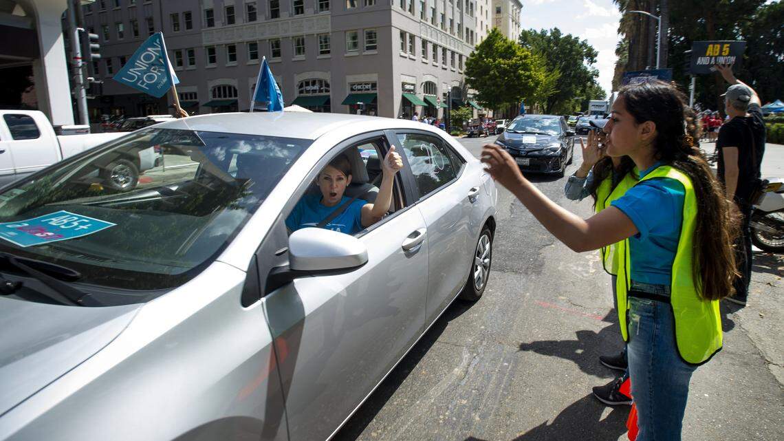 A ride-hailing driver circles the Capitol building In August 2019 to support AB 5. The bill attempted to force “gig economy” employers to treat independent contractors as employees, but Proposition 22 later exempted app-based drivers.