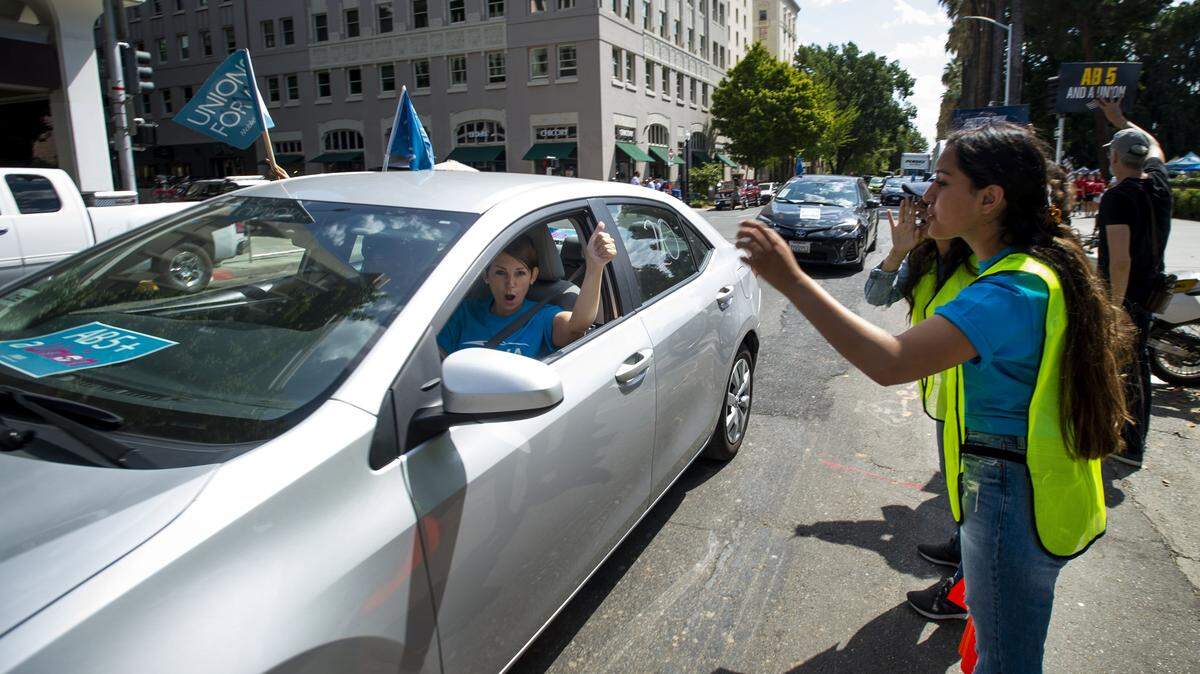 A ride-hailing driver circles the Capitol building In August 2019 to support AB 5. The bill attempted to force “gig economy” employers to treat independent contractors as employees, but Proposition 22 later exempted app-based drivers.