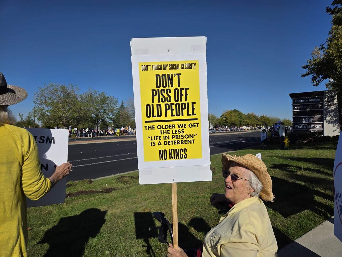 Sue Bassett, 82 of Citrus Heights, holds up her sign in Roseville at the “No Kings” protest Saturday, Oct. 18, 2025.
