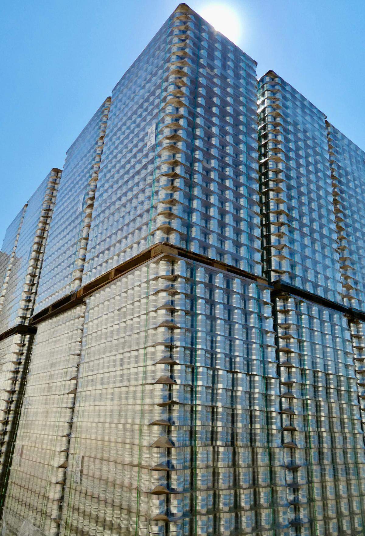 A tower of cans at a tomato processing plant.
