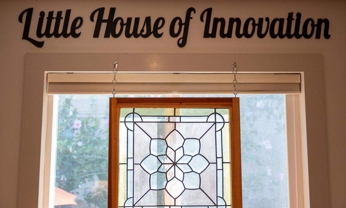 “Little House of Innovation” is written on the wall inside Rebekah Christensen’s tiny home on 22nd Street in Boulevard Park on Sunday, Aug. 25, 2024.
