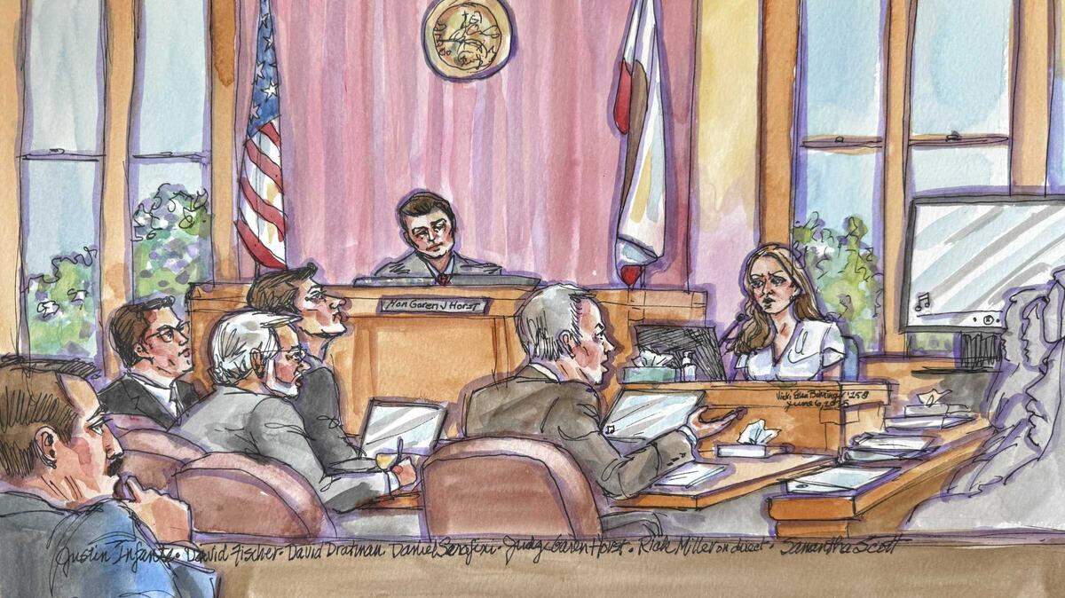 In a wide view of Judge Garen J. Horst’s courtroom in Auburn, prosecutor Richard Miller questions key witness Samantha Scott. A former nanny and romantic partner of defendant Daniel Serafini, Scott described how she helped him dispose of evidence after the fatal 2021 Lake Tahoe shooting of his wife’s parents.
