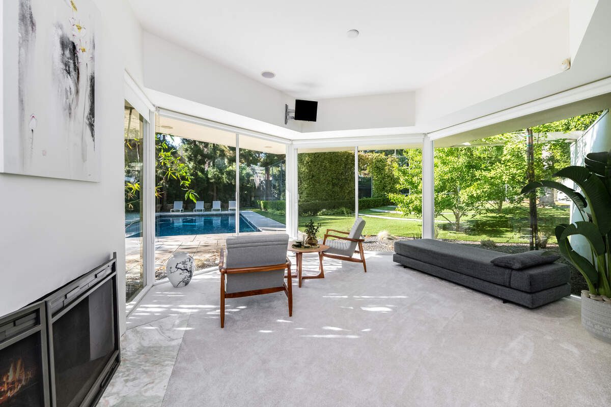 Original mid-century details include iconic floor-to-ceiling glass walls that flood the interiors with natural light, terrazzo flooring and stone accent walls.
