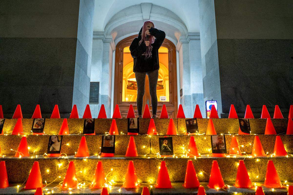 Erika Pringle pauses emotionally while speaking about her brother Andrew Pringle at a vigil she organized on the World Day of Remembrance for Road Traffic Victims at the state Capitol on Nov. 16, 2025. Andrew, pictured below center, was killed in 2023 when a driver ran a red light while he rode his skateboard. Erika organized the event to support other victims of what she calls “vehicular homicide.”