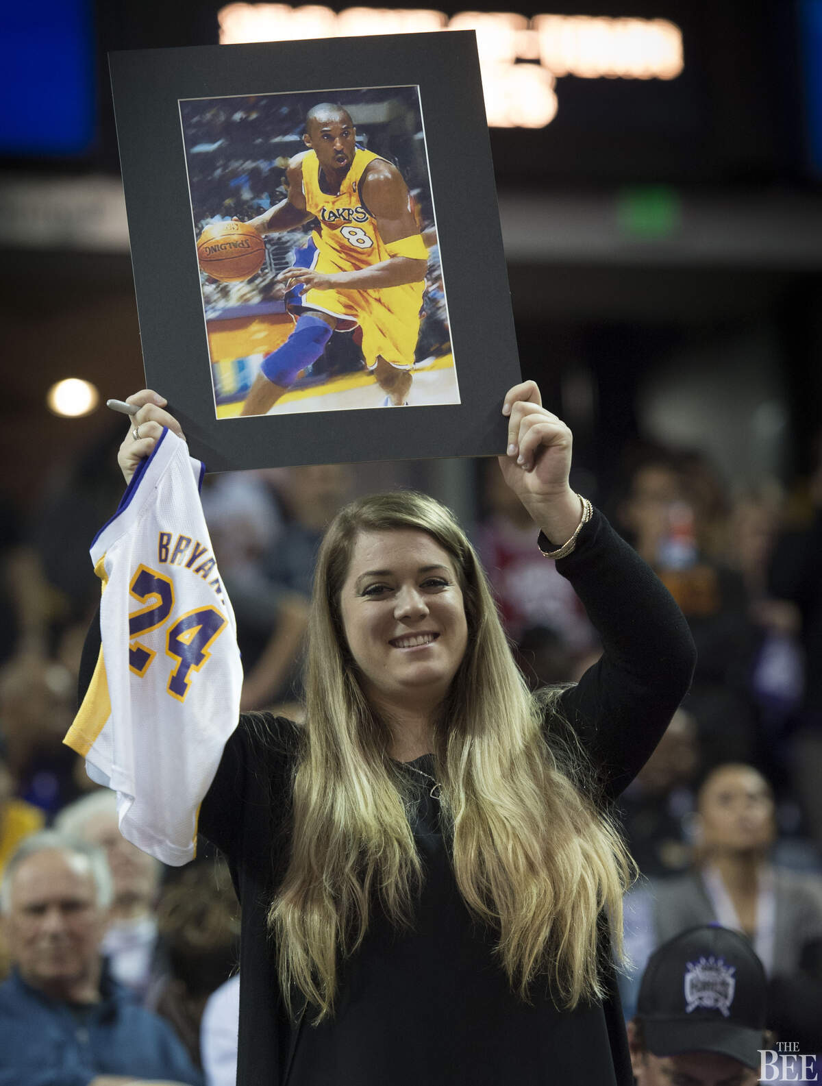 Kobe Bryant fan Shelby Kelch, of Sacramento, holds a Bryant poster during his last game.