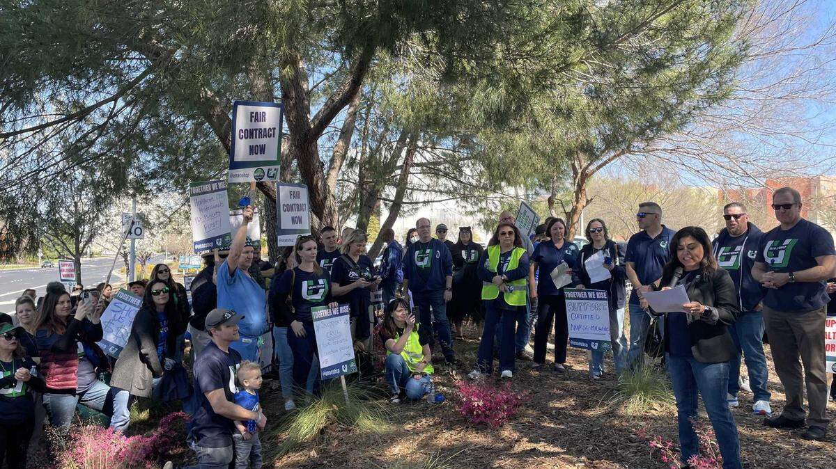 Union workers and supporters look on as Charmaine Morales, president of United Nurses Associations of California/Union of Health Care Professionals, speaks at a rally at Kaiser Permanente Roseville Medical Center on March 11.