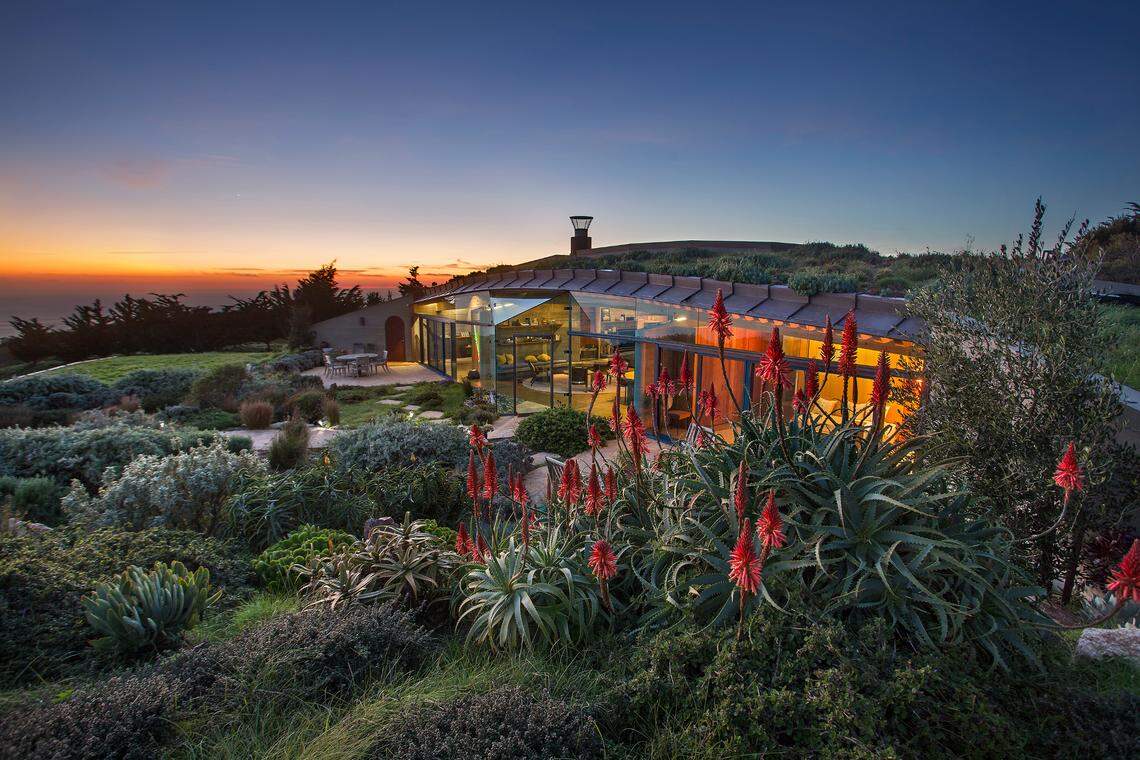 A 2004 Big Sur home designed by architect Mickey Muennig is going on sale for the first time ever at $35 million. The modern, eco-friendly home features huge walls of glass and is built into a ridge with a sod roof in a way that makes it “disappear into the landscape,” according to Coldwell Banker Realty.