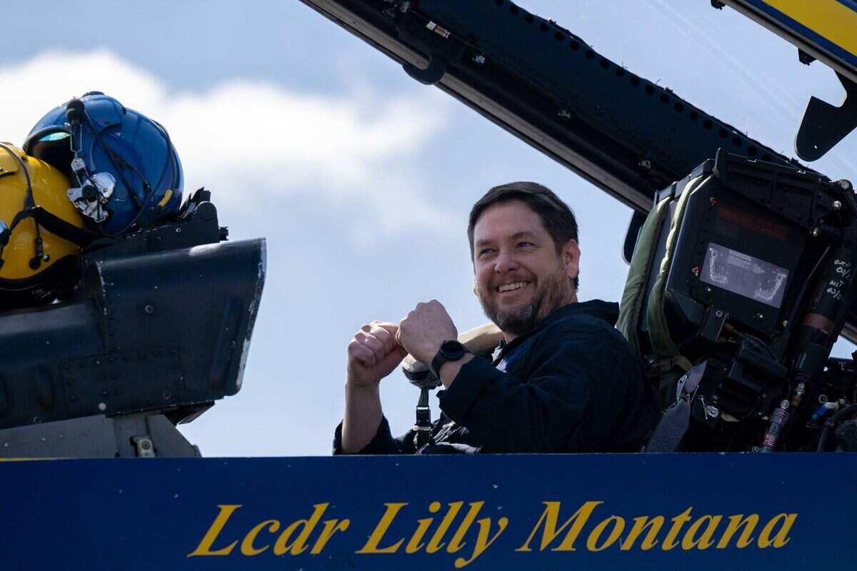 Mills Middle School teacher Jason McKnight, shows his excitement as his students support on his 45-minute flight with Blue Angels pilot Maj. Scott Laux at Mather Airport on Tuesday.