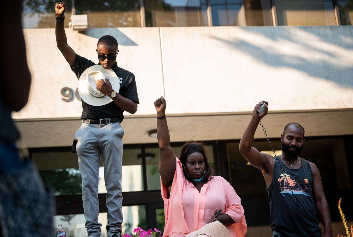Se’Quette&nbsp;Clark, center, mother of Stephon Clark, who was killed by Sacramento police in 2018, stands next to her other son and activist Stevante Clark during a moment of silence in solidarity with the family of Jacob Blake during the Justice for Jake event outside the Sacramento County District Attorney’s Office on Wednesday, Aug. 26, 2020, in downtown Sacramento. 