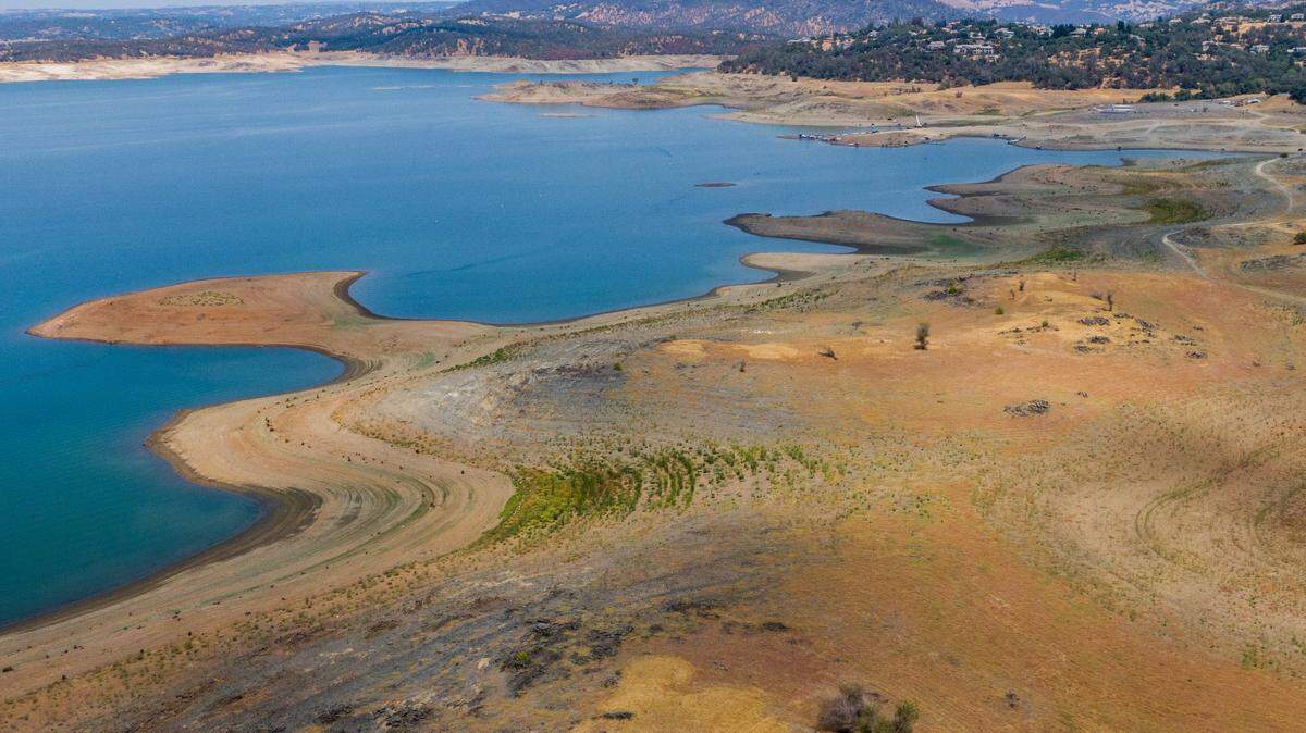 Low water levels leave much of the lakebed exposed at Folsom Lake on Sunday, July 25, 2021, when the reservoir’s surface elevation was 377 feet. The lake holds about a third of its normal amount of water for this time of year. 