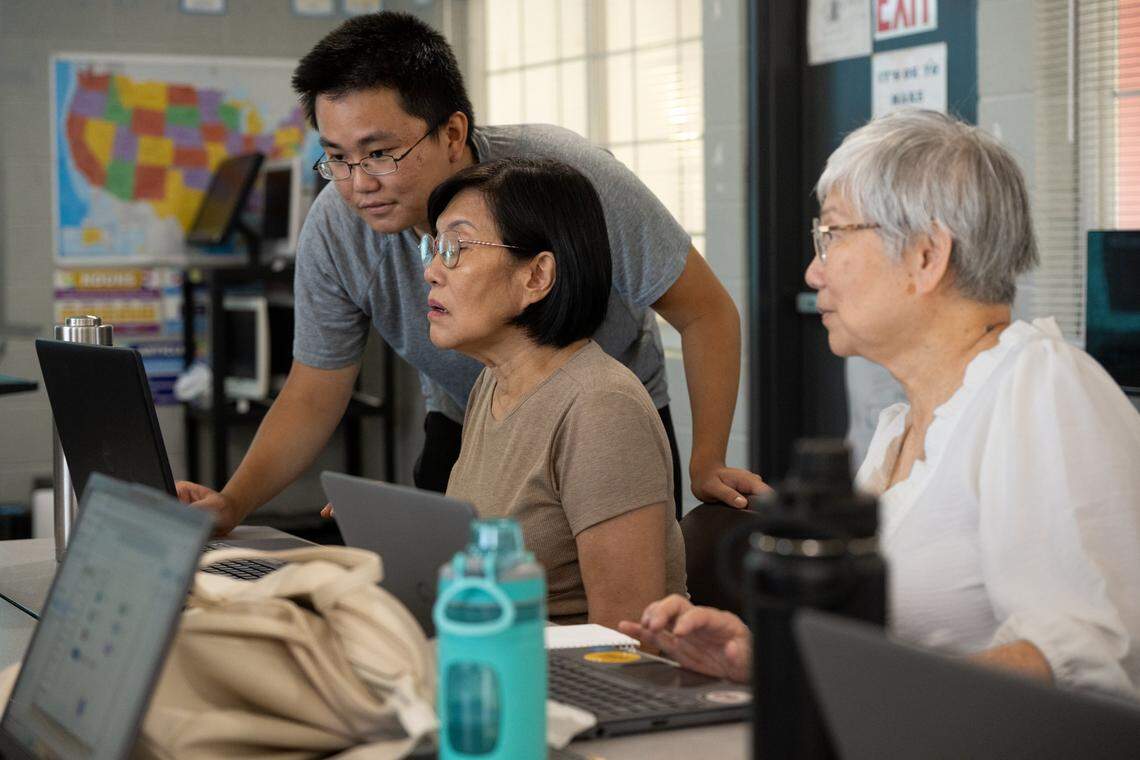 Sacramento Sate student Sheng-Chang Chen helps Trinh Ly, 67, create a PDF during a digital literacy class at the Asian Resources Inc. in Sacramento last month. Sacramento State digital navigators — students trained to teach digital literacy — help residents of the Lemon Hill neighborhood gain command of computer skills that will help them at home and in the workplace.