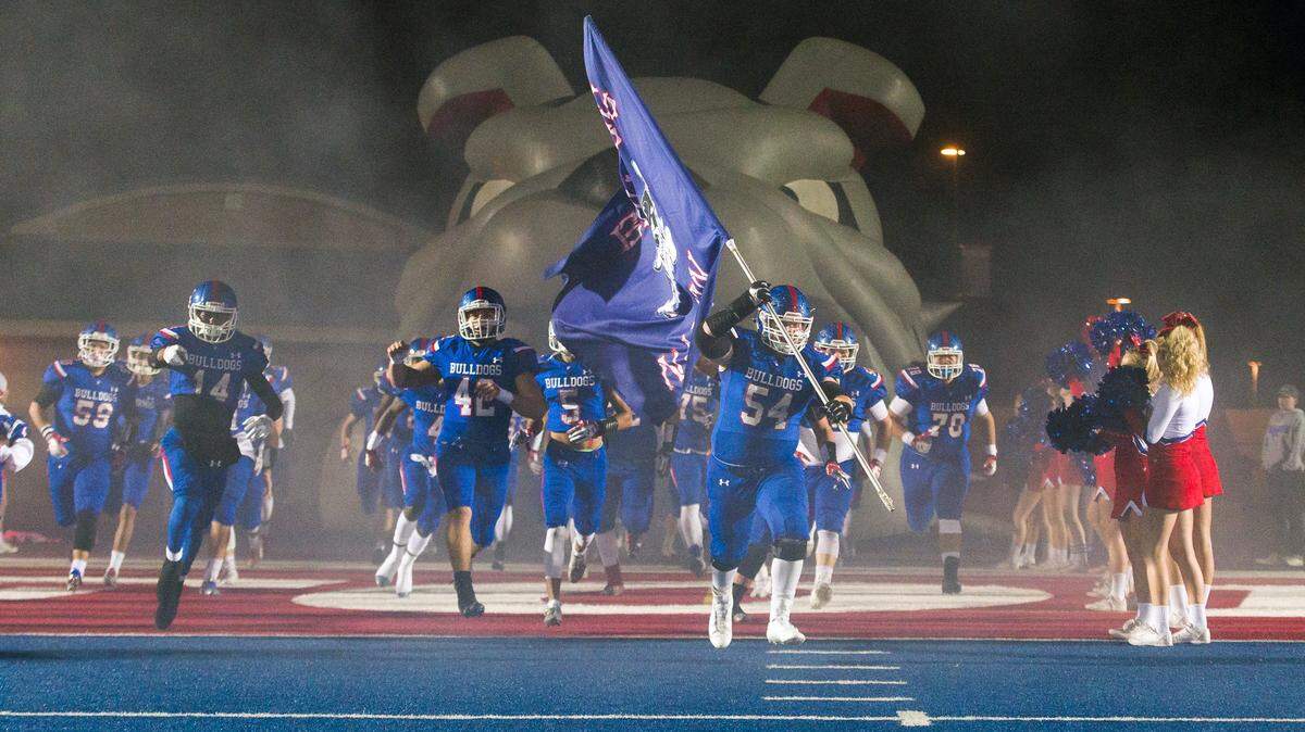 The Folsom Bulldogs come on the to the field before hosting the Jesuit Marauders in a Sac-Joaquin Section Division I third-round playoff game, Friday Nov. 24, 2017.