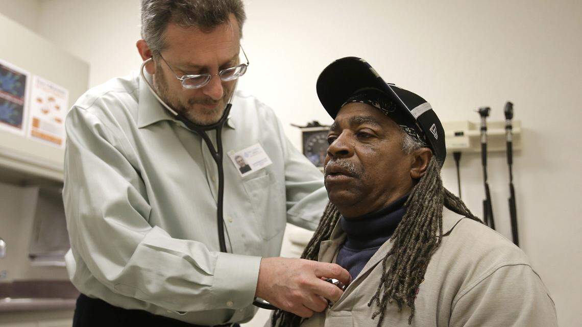 In this photo taken Thursday, Feb. 18, 2016, Dr. Leonid Basovich  examines Medi-Cal patient Michael Epps, at the WellSpace Health clinic in Sacramento.