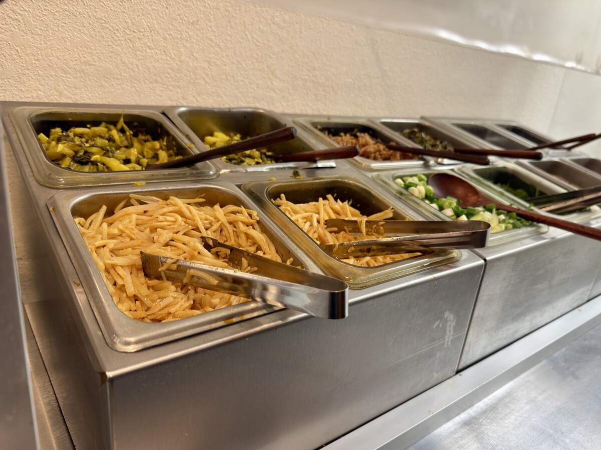 Old Gui Lin at 5131 Freeport Blvd. offers a self-serve bar of condiments for its noodle dishes including chili oil, peanuts, fried soybeans, cilantro, green onions and fermented bamboo and mustard greens on June 15, 2026.