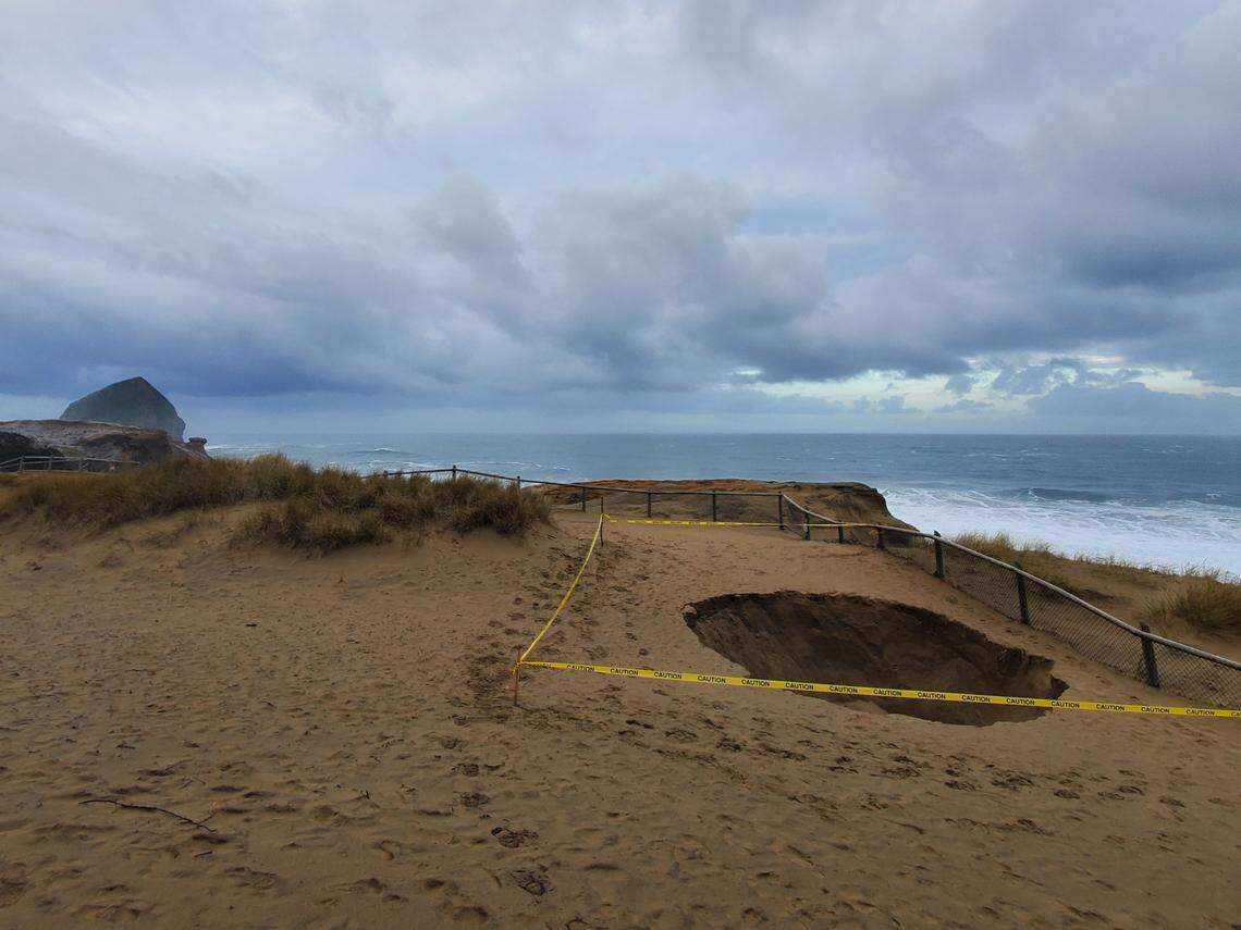 A sinkhole was spotted forming along a cliffside at Cape Kiwanda State Natural Area, near Pacific City, Oregon, on Jan. 22, 2023, park officials said