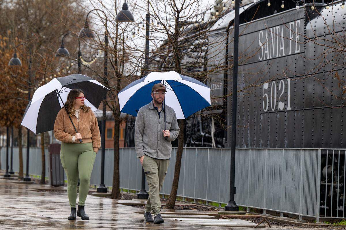 Samuel Braybrooks and Lisa Wilcox of Citrus Heights tour Old Sacramento with their umbrellas on Monday, Feb. 16, 2026.