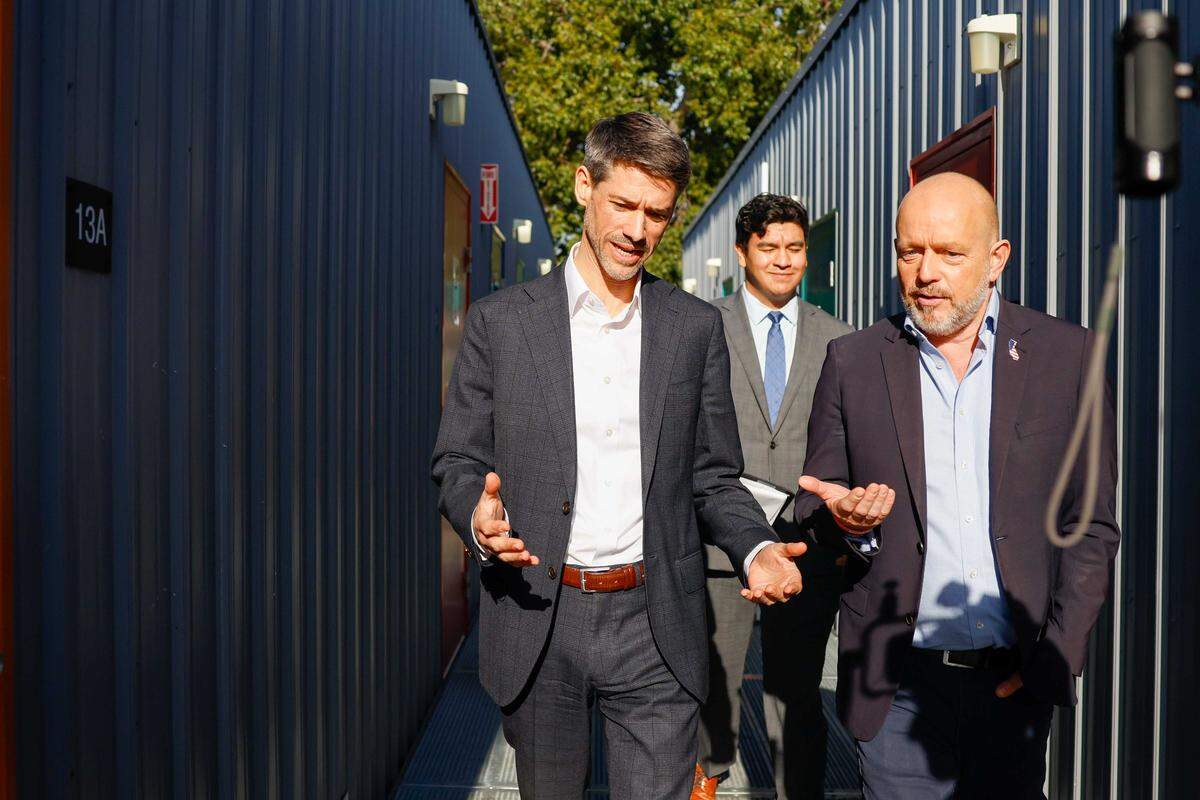 San Jose Mayor Matt Mahan, left, speaks to Steve Hilton, a Republican candidate for governor, while touring Guadalupe Emergency Interim Housing Site earlier this month in San Jose. Mahan announced Thursday that he would run for governor in this year’s election.