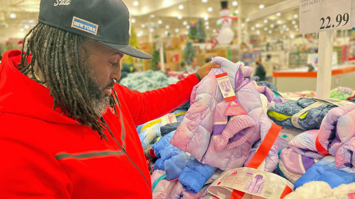 Voice of the Youth founder Berry Accius shops for coats to give to children on Wednesday.