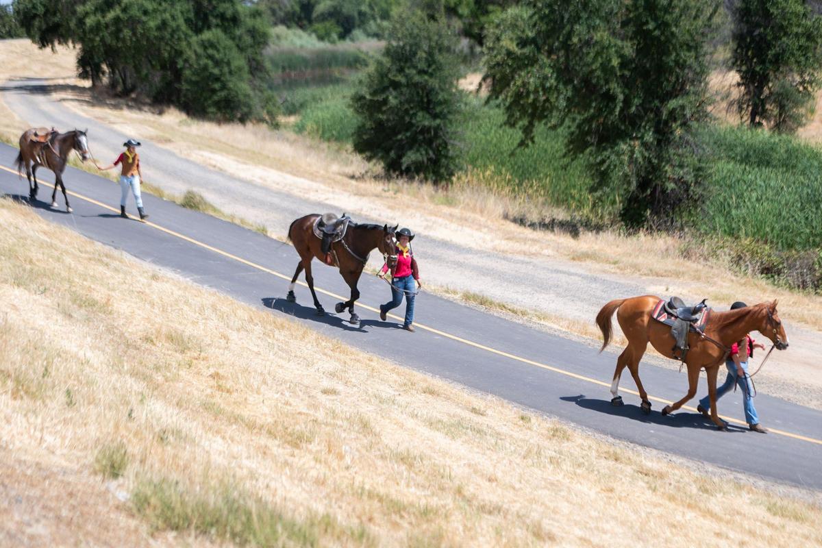 Three Pony Express riders walk their horses during the Annual Re-Ride on Thursday near Expo Parkway in Sacramento. An online map showed riders’ locations with updates every five minutes from a GPS tracker carried in their mochila.