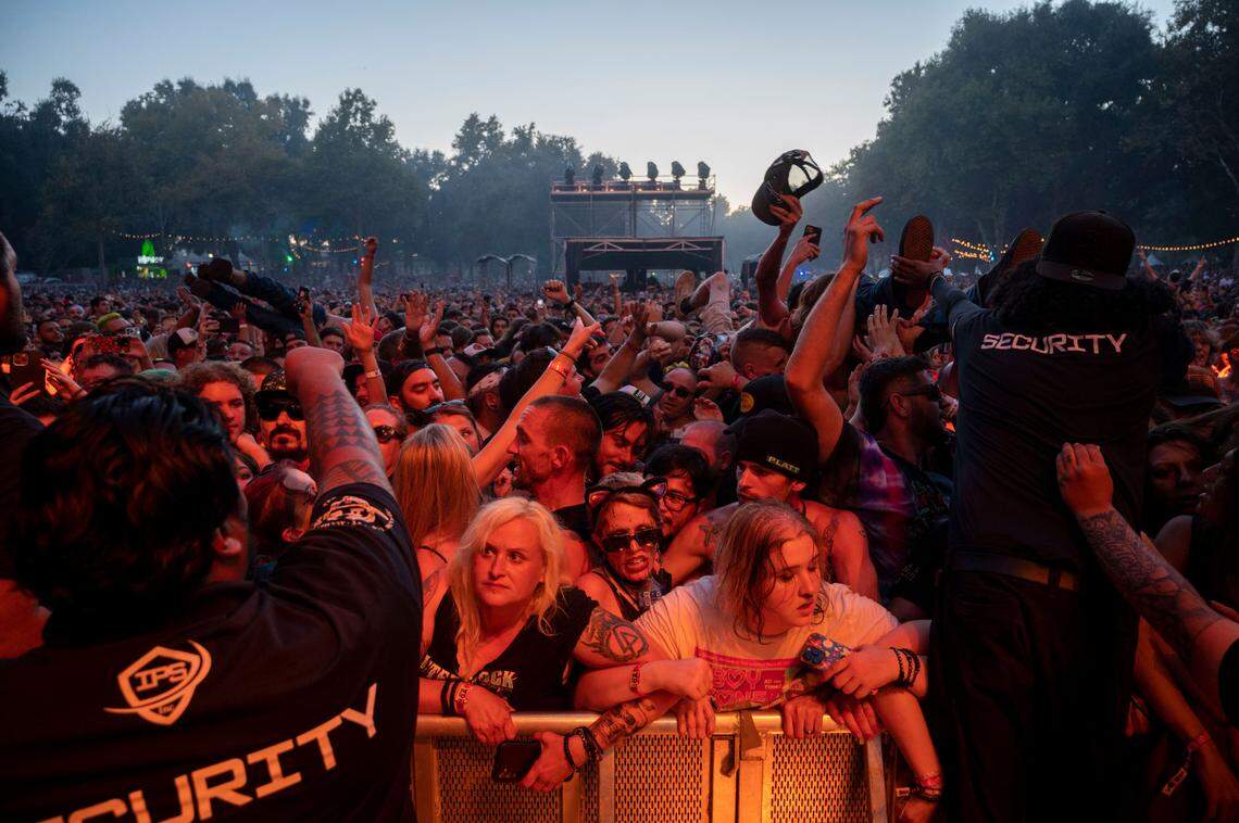 Security prepare to grab crowd surfers as they are dumped in front of the stage during a performance at Aftershock in 2023. 